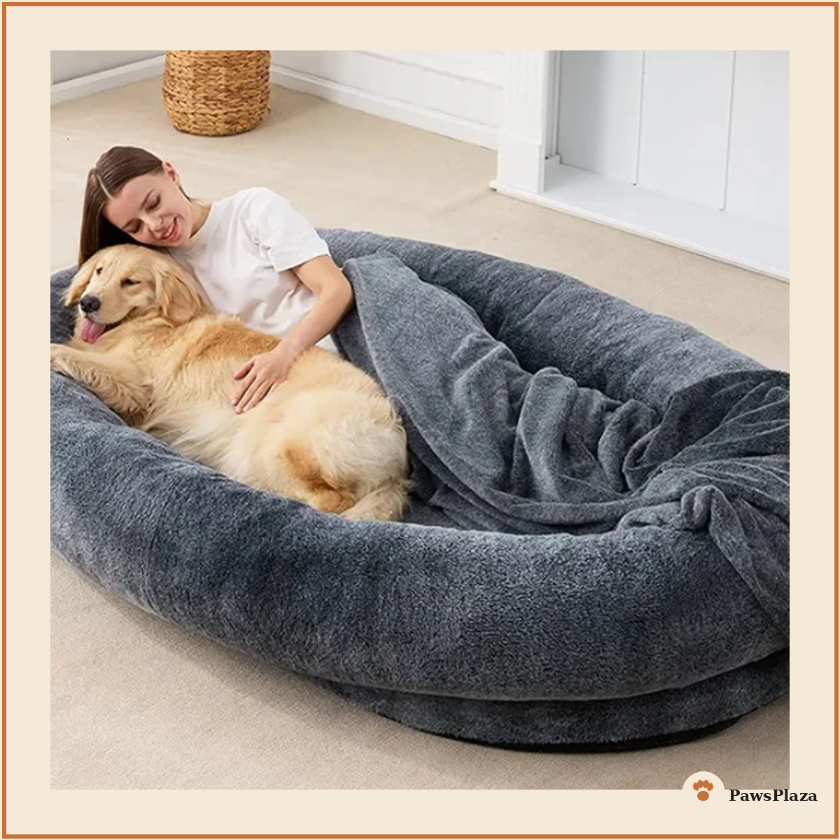 Woman relaxing with golden retriever in large plush human-sized dog bed, dark grey